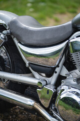 Detail shot of a metallic engine and bodywork of a custom motorcycle.