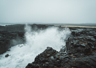 Dramatic Volcanic Coastline with Ocean Waves and Dark Basalt Cliffs in Iceland