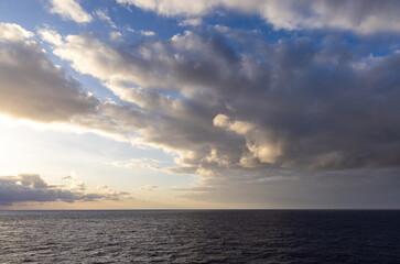 Fototapeta premium Cloudscape Over Calm Ocean During Sunset With Dramatic Clouds and Faint Horizon