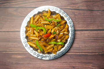 BBQ Pasta served in plate isolated on wooden background top view of Bangladeshi food