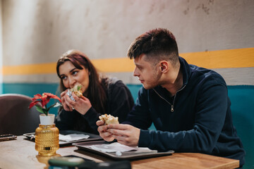 A pair of young friends dine together at a casual restaurant, enjoying wraps and conversation, surrounded by a warm interior ambiance.
