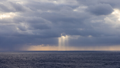 Sun Rays Breaking Through Clouds Over the Pacific Ocean at Dusk