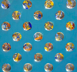Abstract rendering of marbles arrayed in a pattern against a blue background