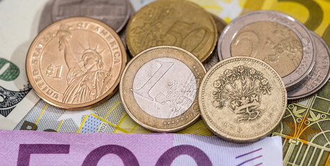 dollar, pound, euro coin on euro background.