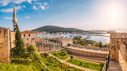 Panoramic view of the medieval Cesme Castle, with its minaret and ramparts, overlooking the harbor,...