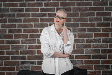 Portrait of a beautiful young caucasian woman with shaved head. Female cancer survivor. Smiling...
