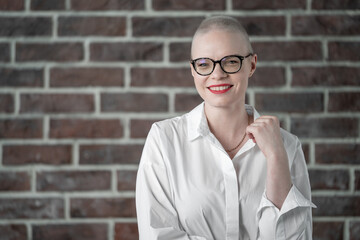 Portrait of a beautiful young caucasian woman with shaved head. Female cancer survivor. Smiling...