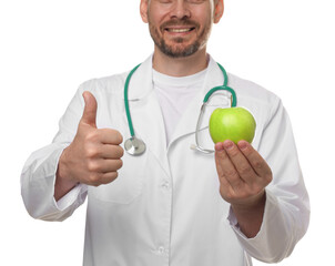Nutritionist with green apple and stethoscope showing thumbs up on white background, closeup