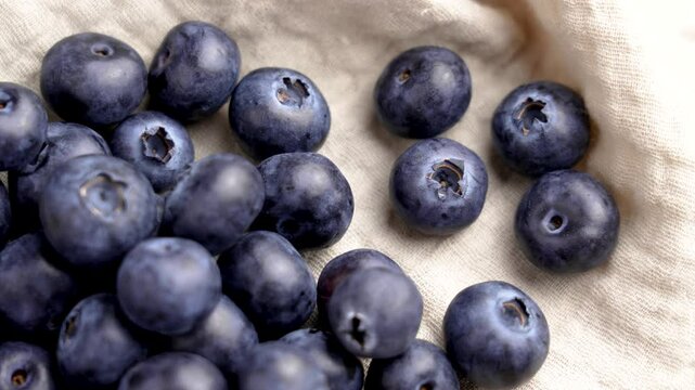Organic blueberries on crumpled fabric close-up. Top view. Rotation