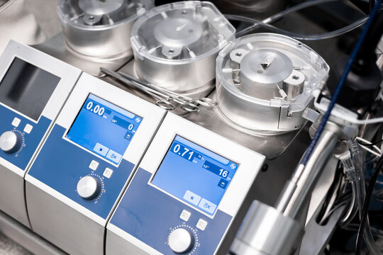 Cardiopulmonary bypass pumps takes over the heart and lungs during cardiosurgery, maintaining the blood circulation, with instuments, clamps. The CPB pump machine. Medical equipment. Advertising. 