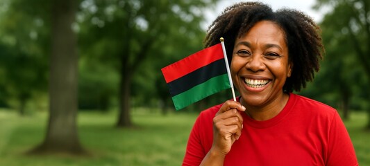 Smiling african american woman holding a pan-african flag outdoors celebrating juneteenth. concept of freedom, cultural pride, joyful celebration, unity, african heritage, Banner, copy space