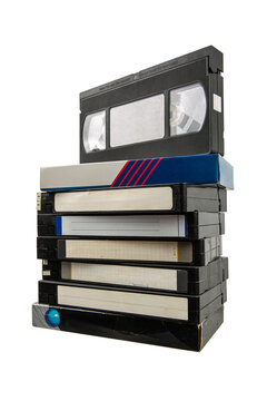 Stack of old VHS tapes with blank labels, isolated on transparent background.