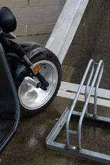 Scooter Wheel and Bike Rack on Rainy Day