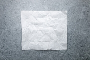 White square paper top view on stone grey background, food advertisement banner, frame. Product promotion,bakery sheet flat lay.