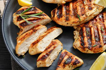 grilled chicken breast with lemon on a plate