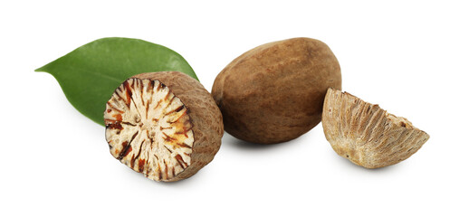 Whole, cut nutmegs and leaf isolated on white