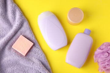 Different bath accessories on yellow background, flat lay