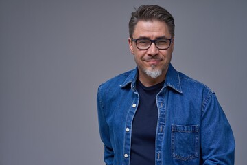 Portrait of mature age, middle age, mid adult casual man, happy smiling. Isolated on gray.