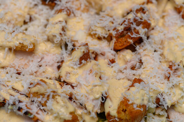 Fresh Caesar salad with lettuce, croutons, cheese, and dressing. Close-up of tasty classic dish.