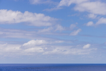 Serene Ocean View With Blue Sky and Gentle Floating Clouds