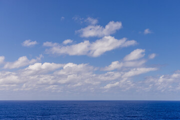 Peaceful Ocean With Blue Sky and White Clouds Overhead