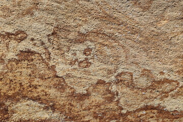 Intricate textures of natural granite stone captured in warm earthy tones background.