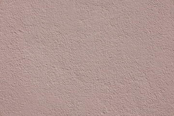 Intricate texture of a painted  in soft pink  outdoors concret wall backdrop 