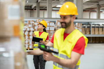 Warehouse workers conduct an inventory check, ensuring accurate tracking and management of products in a busy environment.
