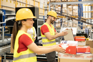 Warehouse workers are focused on organizing boxes, emphasizing teamwork and the importance of...