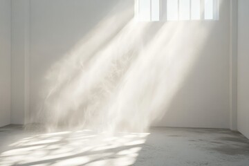 Fototapeta premium Sunbeams illuminate a dust-filled white room, creating ethereal light and shadow patterns.