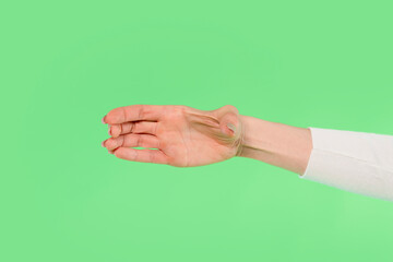 Unique art manipulation showing a hand and arm blending into an abstract shape on a bright green...