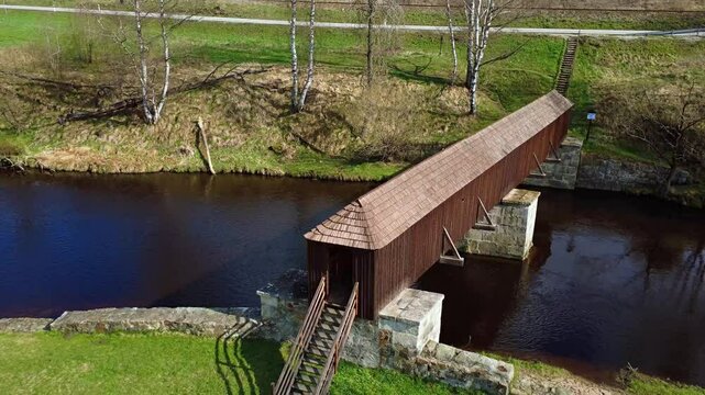 The picturesque covered wooden bridge Rechle near Lenora in the &Scaron;umava mountains &ndash; a unique national cultural monument - historic bridge with a wooden deck and stone pillars