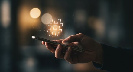 Hand holding smartphone displaying hashtag symbol concept of social media day  