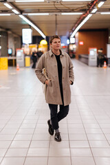 Young stylish person waiting in a modern station hall
