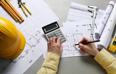 Architect working with project, top view. Different technical drawings and construction tools on...