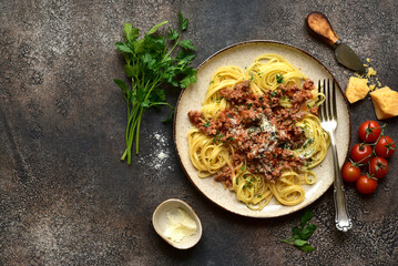 Traditional italian spaghetti bolognese with tomatoes and minced meat. Top view with copy space.