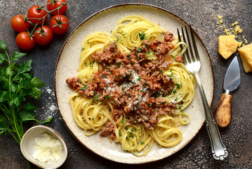 Traditional italian spaghetti bolognese with tomatoes and minced meat. Top view with copy space.
