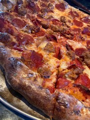 large hot pizza with sausage and pepperoni