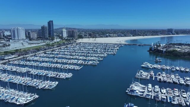 Aerial Long Beach city California marina overhead circle 1. Coastal city near Los Angeles. Cargo and container ship terminal. Cruise ship destination. Seaside resort boat marina and park.