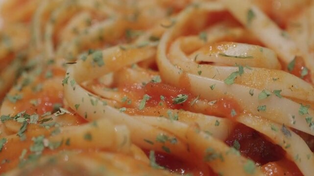 linguini spaghetti with meatballs and mediterranean sauce served on a white plate	