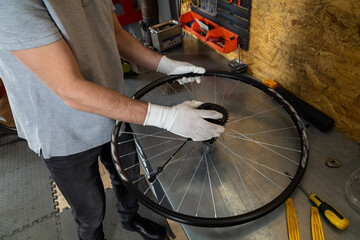 Mechanic in white gloves adjusting wheel