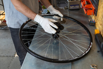 Mechanic adjusting bike wheel