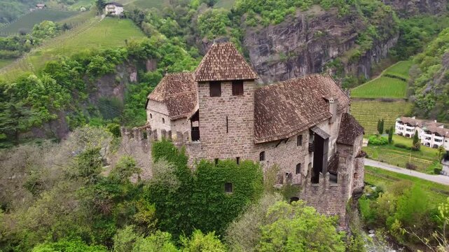 Ancient Roncolo Castle perched amidst green hills in South Tyrol, Italy