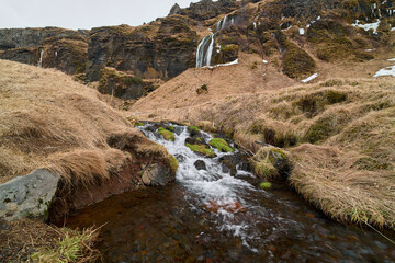 Small river flowing through icelandic landscape
