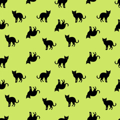 Repeating black cat silhouettes on bright green background, ideal for Halloween or themed textiles and wallpapers. Vector art