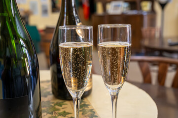 Pouring and tasting of dry sparkling wine brut, grand reserve, champagne in Ay-Champagne wine making village in Vallee de la Marne, , Champagne region, France