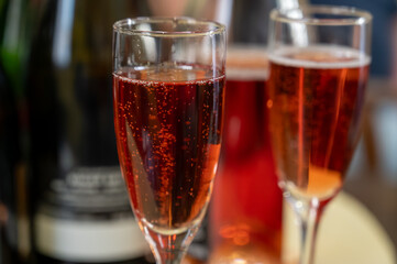 Pouring and tasting of rose or pink cuvee sparkling wine brut, grand reserve, champagne in Ay-Champagne wine making village in Vallee de la Marne, , Champagne region, France