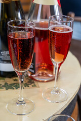 Pouring and tasting of rose or pink cuvee sparkling wine brut, grand reserve, champagne in Ay-Champagne wine making village in Vallee de la Marne, , Champagne region, France