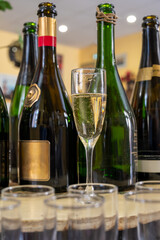 Pouring and tasting of dry sparkling wine brut, grand reserve, champagne in Ay-Champagne wine making village in Vallee de la Marne, , Champagne region, France