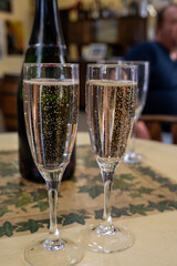 Pouring and tasting of dry sparkling wine brut, grand reserve, champagne in Ay-Champagne wine making village in Vallee de la Marne, , Champagne region, France